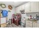 Well-equipped laundry room with washer, dryer, utility sink, and overhead cabinets at 1165 Maclaren Ct, Franklin, IN 46131