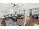 Bright open-concept living space with hardwood floors, comfortable seating, and a view into the modern kitchen at 1165 Maclaren Ct, Franklin, IN 46131