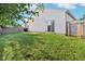 A home's back yard featuring a well-maintained lawn and partial fencing at 12604 Buck Run Dr, Noblesville, IN 46060