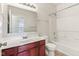 Well-lit bathroom with white walls, a wood vanity with a white countertop, and a shower-tub combination at 12604 Buck Run Dr, Noblesville, IN 46060