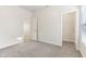 Bright bedroom featuring neutral carpet, natural light, a closet, and a hallway entrance for easy access at 12604 Buck Run Dr, Noblesville, IN 46060