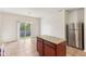 Bright kitchen features an island, stainless steel refrigerator, and sliding glass door leading to the backyard at 12604 Buck Run Dr, Noblesville, IN 46060