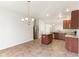 Open kitchen with tiled floor, stainless steel refrigerator, and granite countertops at 12604 Buck Run Dr, Noblesville, IN 46060