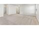 Open-concept living space with plush carpeting and seamless transitions to other rooms at 12604 Buck Run Dr, Noblesville, IN 46060