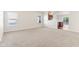 Bright living area with neutral carpeting and views of the kitchen and dining space at 12604 Buck Run Dr, Noblesville, IN 46060