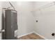 Utility room featuring tile floor, water heater, shelving, and utility hookups at 12604 Buck Run Dr, Noblesville, IN 46060