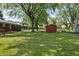A large backyard with mature trees and green grass at 1346 Carroll White Dr, Indianapolis, IN 46219