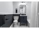 Charming bathroom with navy vanity, updated fixtures, and a shower-tub combination at 1346 Carroll White Dr, Indianapolis, IN 46219
