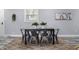 Cozy dining room with modern table set, decorative rug, and natural light from the window at 1346 Carroll White Dr, Indianapolis, IN 46219
