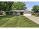 A lovely home featuring a well-manicured lawn and a two-car garage at 1346 Carroll White Dr, Indianapolis, IN 46219