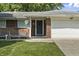 Close-up of a charming brick home featuring a well-kept lawn and a welcoming front entrance at 1346 Carroll White Dr, Indianapolis, IN 46219