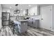 Renovated kitchen with an island, subway tile backsplash, and stainless steel appliances at 1346 Carroll White Dr, Indianapolis, IN 46219