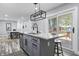 Kitchen island with seating, granite countertops, a modern faucet, and sliding glass doors to the deck at 1346 Carroll White Dr, Indianapolis, IN 46219