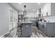 Bright kitchen featuring an island, stainless steel appliances, and sliding glass doors to the deck at 1346 Carroll White Dr, Indianapolis, IN 46219