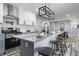 Stylish kitchen boasts stainless steel appliances, white cabinets, subway tile backsplash, and an island with seating at 1346 Carroll White Dr, Indianapolis, IN 46219