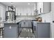 Bright kitchen featuring gray and white cabinets, stainless steel appliances, granite countertops, and an island at 1346 Carroll White Dr, Indianapolis, IN 46219