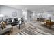 Bright living room featuring hardwood-style floors, modern furniture, and recessed lighting at 1346 Carroll White Dr, Indianapolis, IN 46219