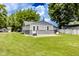 Rear view of a single-story home set in a well-kept lawn at 1511 E 20Th St, Muncie, IN 47302