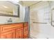 Bathroom featuring a dark wood vanity, a new shower and matching fixtures and a window at 1511 E 20Th St, Muncie, IN 47302