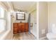 Bathroom with a wooden vanity, shower, and a window at 1511 E 20Th St, Muncie, IN 47302