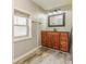 Bathroom with a wooden vanity, wood-look floors, new light fixtures, and a large window at 1511 E 20Th St, Muncie, IN 47302