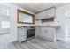 Functional kitchen featuring neutral paint, gray vinyl flooring, and ample counter space at 1511 E 20Th St, Muncie, IN 47302
