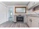 Modern kitchen features stainless steel appliances, grey cabinets, and a unique wooden-framed mirror backsplash at 1511 E 20Th St, Muncie, IN 47302
