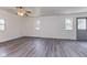Spacious living room with new flooring, freshly painted walls, two windows, and ceiling fan at 1511 E 20Th St, Muncie, IN 47302