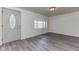 Cozy living room featuring gray vinyl flooring, freshly painted white walls and a large window at 1511 E 20Th St, Muncie, IN 47302