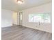 Bright and open living room with fresh neutral paint, gray vinyl flooring, and a big window at 1511 E 20Th St, Muncie, IN 47302