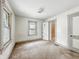 Cozy bedroom featuring two windows and a view to the bath at 1550 Hoefgen St, Indianapolis, IN 46203