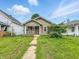 Quaint one-story home featuring a front porch, and a walkway leading up to the entrance at 1550 Hoefgen St, Indianapolis, IN 46203
