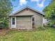 Rear exterior of home features plain siding, window AC unit, and access door at 1550 Hoefgen St, Indianapolis, IN 46203