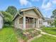 Charming home with a front porch, red and white trim, and potential for landscaping at 1550 Hoefgen St, Indianapolis, IN 46203