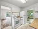 Galley style kitchen with view of the stove, refrigerator and doorway to other rooms at 1550 Hoefgen St, Indianapolis, IN 46203