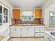 Galley kitchen includes a double basin sink and window above a brick backsplash at 1550 Hoefgen St, Indianapolis, IN 46203
