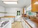 Galley kitchen featuring a vintage gas range, butcher block counters, and an exterior door at 1550 Hoefgen St, Indianapolis, IN 46203