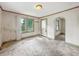 Bright living room featuring a window and a front door with decorative wood trim and a vintage light fixture at 1550 Hoefgen St, Indianapolis, IN 46203