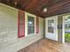Enclosed porch featuring painted wood ceiling, and a storm door at 1550 Hoefgen St, Indianapolis, IN 46203