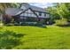 A spacious backyard showcases this home's exterior and a well-manicured lawn at 160 Scranton Ct, Zionsville, IN 46077