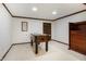 This carpeted basement includes a foosball table, a storage cabinet, and is well lit by recessed lighting at 160 Scranton Ct, Zionsville, IN 46077