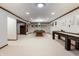 This basement is spacious and features a pool table, a shuffleboard, and a neutral-colored carpet at 160 Scranton Ct, Zionsville, IN 46077