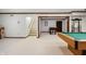 This carpeted basement features stairs, a pool table and a foosball table for entertainment at 160 Scranton Ct, Zionsville, IN 46077