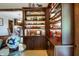 Custom floor-to-ceiling bookcase with cabinet doors and detailed shelving display illuminated by individual integrated lights at 160 Scranton Ct, Zionsville, IN 46077