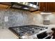 Close up on the modern stainless steel stove and gray backsplash in kitchen at 160 Scranton Ct, Zionsville, IN 46077