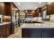 Spacious kitchen featuring a stainless steel refrigerator, custom cabinets, and an island at 160 Scranton Ct, Zionsville, IN 46077