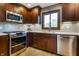 Modern kitchen with stainless steel appliances, custom cabinets, and ample counter space at 160 Scranton Ct, Zionsville, IN 46077
