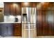 Modern kitchen features stainless steel refrigerator and abundant custom cabinet space at 160 Scranton Ct, Zionsville, IN 46077