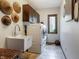 This laundry room features modern washer and dryer, custom cabinets, a sink, and a window at 160 Scranton Ct, Zionsville, IN 46077