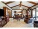 A beautiful open-concept living room featuring hardwood floors, wooden beams, custom cabinets, and an inviting seating area at 160 Scranton Ct, Zionsville, IN 46077